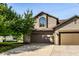 Charming two-story home with a well-manicured lawn and an attached two-car garage at 2247 Frisco Pl, Indianapolis, IN 46240