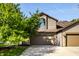 Charming two-story home with a well-manicured lawn and an attached two-car garage at 2247 Frisco Pl, Indianapolis, IN 46240