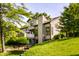 Exterior view of a townhouse with a well-manicured lawn and mature trees at 2247 Frisco Pl, Indianapolis, IN 46240