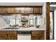 Kitchen with functional layout opens to view of stone fireplace in living room with natural light at 2247 Frisco Pl, Indianapolis, IN 46240