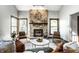 Cozy living room featuring a stone fireplace, wood floors, and comfortable seating at 2247 Frisco Pl, Indianapolis, IN 46240