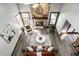 Living room with stone fireplace, wood flooring, and large windows letting in natural light at 2247 Frisco Pl, Indianapolis, IN 46240