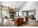 Bright living room featuring a stone fireplace, wood floors, and modern furniture at 2247 Frisco Pl, Indianapolis, IN 46240