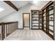Bright loft space with a built-in bookcase, neutral carpet, and a doorway leading to another room at 2247 Frisco Pl, Indianapolis, IN 46240