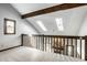 Upstairs loft area with skylights and view of the living room's stone fireplace at 2247 Frisco Pl, Indianapolis, IN 46240