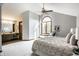 Spacious primary bedroom with vaulted ceiling, arched window and an ensuite bathroom at 2247 Frisco Pl, Indianapolis, IN 46240