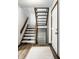 Classic staircase with wooden railings, plush carpeting, and a bright white door at 2247 Frisco Pl, Indianapolis, IN 46240