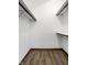 Walk-in closet with a laminate floor and minimalist shelving and hanging racks at 2247 Frisco Pl, Indianapolis, IN 46240