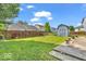 Backyard featuring well-maintained grass, shed, and wood fence at 2309 Westmere Dr, Plainfield, IN 46168