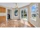 Dining area with wood floors, cabinetry, a window, and sliding glass doors to the backyard at 2309 Westmere Dr, Plainfield, IN 46168