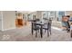 Bright dining area open to kitchen, featuring a table, carpeting and natural light at 2309 Westmere Dr, Plainfield, IN 46168