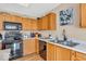 The kitchen features wooden cabinets, modern appliances, a sink, and light countertops at 2309 Westmere Dr, Plainfield, IN 46168