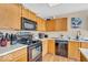 Kitchen featuring stainless steel appliances, wooden cabinets, light countertops, and a decorative backsplash at 2309 Westmere Dr, Plainfield, IN 46168