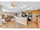 Bright kitchen with wood cabinets and black appliances and an island overlooking the open-concept living area at 2309 Westmere Dr, Plainfield, IN 46168