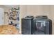 Clean laundry room with modern washer and dryer set and shelving for storage at 2309 Westmere Dr, Plainfield, IN 46168