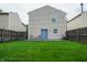 Backyard features a well-maintained lawn, full fencing, and a patio for outdoor living at 2355 Collins Way, Greenfield, IN 46140