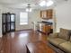 Open-concept living room with hardwood floors, bar with wine rack and refrigerator at 2355 Collins Way, Greenfield, IN 46140