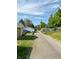 View of the alley with gravel and a blue car parked on the side of the road at 2543 Union St, Indianapolis, IN 46225