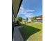 The backyard features a detached garage with dark siding, green grass, and a sidewalk at 2543 Union St, Indianapolis, IN 46225