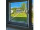 View from a window of a grassy backyard with a small detached garage at 2543 Union St, Indianapolis, IN 46225