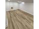 Finished basement area with wooden flooring, bright lighting, and clean, white walls at 2543 Union St, Indianapolis, IN 46225