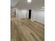 Spacious basement area with wooden floors, modern lighting, and neutral colors at 2543 Union St, Indianapolis, IN 46225