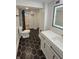 Bathroom featuring a modern vanity, toilet, and hexagonal black and white tile flooring at 2543 Union St, Indianapolis, IN 46225