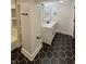 Bathroom featuring a modern vanity, shower, and striking black hexagonal tiles at 2543 Union St, Indianapolis, IN 46225
