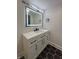 Modern bathroom with a sleek vanity, illuminated mirror, and striking black hexagonal tiles at 2543 Union St, Indianapolis, IN 46225
