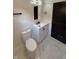 Bathroom with a toilet, cabinet with a sink, modern fixtures, and white marble flooring at 2543 Union St, Indianapolis, IN 46225