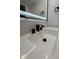 Close-up of a modern bathroom sink with a sleek black faucet and white countertop at 2543 Union St, Indianapolis, IN 46225