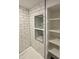 Modern bathroom with white subway tile, shower niche, and open shelving at 2543 Union St, Indianapolis, IN 46225