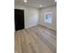 A well-lit bedroom featuring wood-style flooring and a sliding barn door at 2543 Union St, Indianapolis, IN 46225