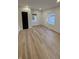 Cozy bedroom featuring wood-look flooring, two windows, and a door at 2543 Union St, Indianapolis, IN 46225