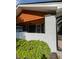 The charming front porch boasts fresh white painted brick and wood ceiling with dark siding at 2543 Union St, Indianapolis, IN 46225