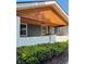 A close up of the front porch, showcasing a wood plank ceiling and freshly painted white brick at 2543 Union St, Indianapolis, IN 46225