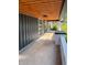 Spacious front porch with concrete flooring, wood plank ceiling, and freshly painted white brick at 2543 Union St, Indianapolis, IN 46225