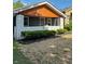 Charming front porch with freshly painted white brick and dark siding and a wood plank ceiling at 2543 Union St, Indianapolis, IN 46225