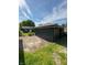 A detached garage with black siding and a concrete driveway sits in the backyard at 2543 Union St, Indianapolis, IN 46225