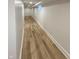 Finished basement hallway with wooden flooring, bright lighting, and white trim at 2543 Union St, Indianapolis, IN 46225