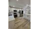 Bright kitchen featuring white cabinets, stainless steel appliances, and wood-look flooring at 2543 Union St, Indianapolis, IN 46225