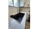 Close-up of kitchen sink with modern faucet, undermount sink, and subway tile backsplash at 2543 Union St, Indianapolis, IN 46225