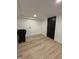 Basement laundry room with utility sink, clean white walls and wooden floors at 2543 Union St, Indianapolis, IN 46225