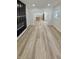 Well-lit living room with luxury vinyl plank flooring leading to the kitchen at 2543 Union St, Indianapolis, IN 46225