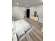 Staged main bedroom with a white bed, light wood dresser, and wood-look flooring at 2543 Union St, Indianapolis, IN 46225