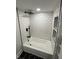 Modern shower featuring white subway tile, black fixtures, and built-in shelving at 2543 Union St, Indianapolis, IN 46225
