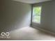 Bright bedroom with neutral walls and a large window, offering ample natural light at 2875 N Dearborn St, Indianapolis, IN 46218