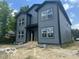 New construction two-story home featuring gray siding and black trim, with large windows at 2875 N Dearborn St, Indianapolis, IN 46218
