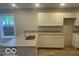 Spacious kitchen boasts granite countertops, stainless steel sink and white cabinets at 2875 N Dearborn St, Indianapolis, IN 46218