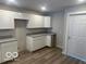 Kitchen featuring granite countertops, white cabinets and stainless steel sink at 2879-81 N Dearborn St, Indianapolis, IN 46218